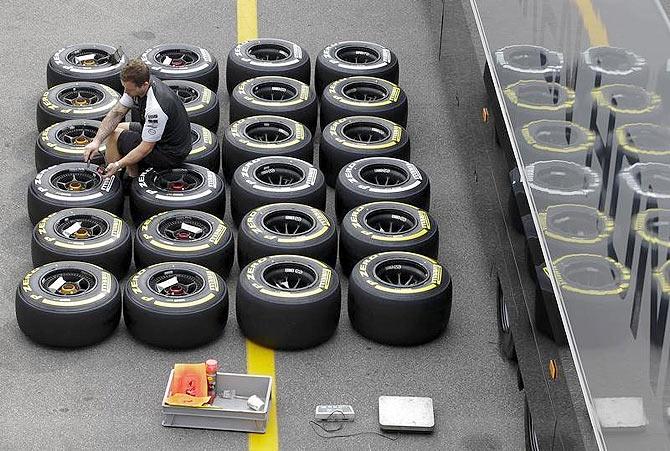 A Mercedes mechanic checks the pressure of Pirelli tyres ahead of the Italian F1 Grand Prix in Monza