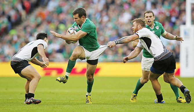 Ireland's Jared Payne and Romania's Mike Wiringi and Csaba Gal in action during their Rugby World Cup Pool D match at Wembley Stadium, London, on Sunday, September 27th