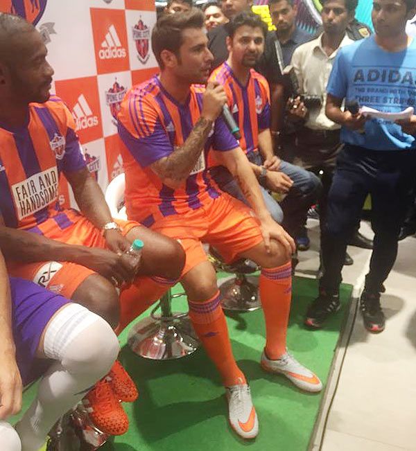 Pune City FC's Adrian Mutu (centre) and Didier Zokora (left) during an interaction with fans