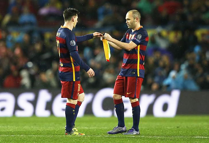 Barcelona's Lionel Messi receives the captain's armband from Andres Iniesta