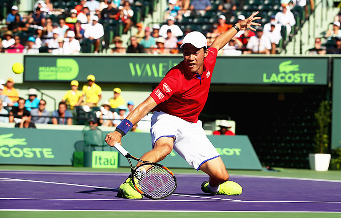 Japan's Kei Nishikori in action against France's Gael Monfils during their quarter-final