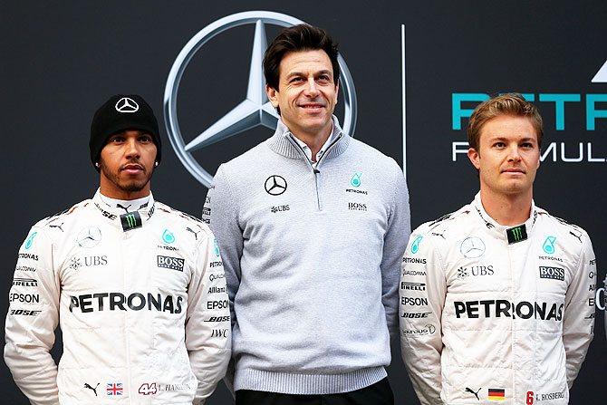 Mercedes GP's drivers Lewis Hamilton (left) and Nico Rosberg (right) pose with Mercedes GP Executive Director Toto Wolff at the unveiling of the new W07 car