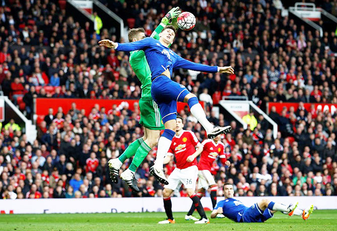 Manchester United's David De Gea gathers the ball from Everton's John Stones