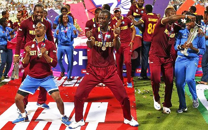 West Indies players Dwayne Bravo and Darren Sammy celebrate with the trophy after winning the World Twenty20 final against England at the Eden Gardens in Kolkata on Sunday