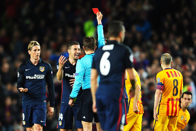 Atletico Madrid's Fernando Torres (left) is is sent off after being shown the red card by referee Felix Brych