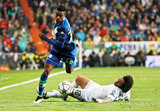 Real Madrid's Marcelo challenges Wolfsburg's Bruno Henrique