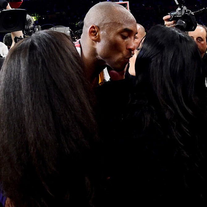 Los Angeles Lakers' guard Kobe Bryant kisses wife Vanessa after playing his final NBA game on Wednesday, April 13