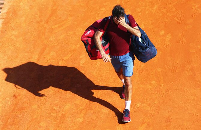 Switzerland's Roger Federer walks off after his loss to Frenchman Jo-Wilfred Tsonga in the quarter-final of the Monte Carlo Masters at Monte-Carlo Sporting Club in Monte-Carlo, Monaco, on Friday