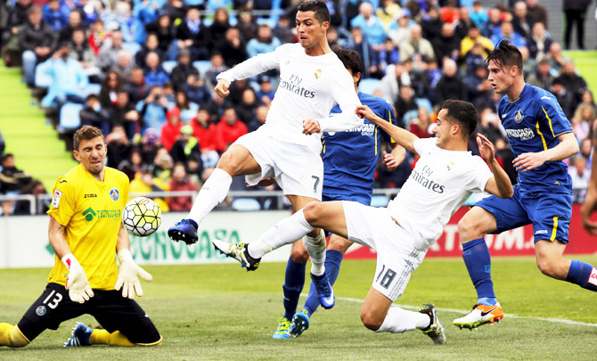 Real Madrid's Cristiano Ronaldo (2nd from left) and Lucas Vazquez vie with Getafe's goalkeeper Vicente Guaita (left) during their La Liga match at Colisseum Alfonso Perez, in Getafe, Spain on Saturday