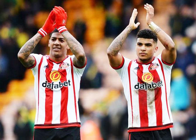 Sunderland's Patrick van Aanholt (L) and DeAndre Yedlin applaud fans as they celebrate after the match against Norwich City on Saturday