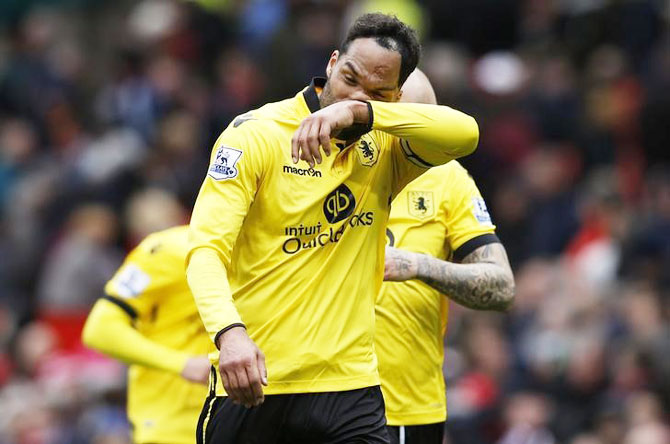 Aston Villa's Joleon Lescott looks dejected after being relegated from the Premier League at the end of their match against Manchester United on Saturday