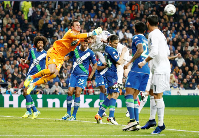 Real Madrid's Gareth Bale tries to head the ball in past Wolfsburg's Ricardo Rodriguez and Diego Benaglio during their UEFA Champions League, quarter-final second leg match at Santiago Bernabeu on Tuesday, April 12.