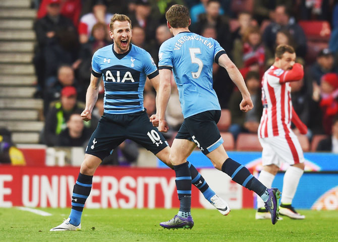 Tottenham Hotspur's Harry Kane (left) celebrates with teammate Jan Vertonghen as he scores their first goal against Stoke City during the Barclays Premier League match at the Britannia Stadium in Stoke on Trent, on Monday