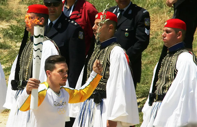 The first torchbearer and reigning world champion gymnast Lefteris Petrounias runs with the torch during the lighting ceremony of the Olympic Flame for the Rio Olympic Games on April 21, 2016 in Olympia, Greece. Torchbearers will carry the Olympic Flame from Ancient Olympia on relay through Greece for eight days before a hand-over ceremony at Panathenian Stadium in Athens