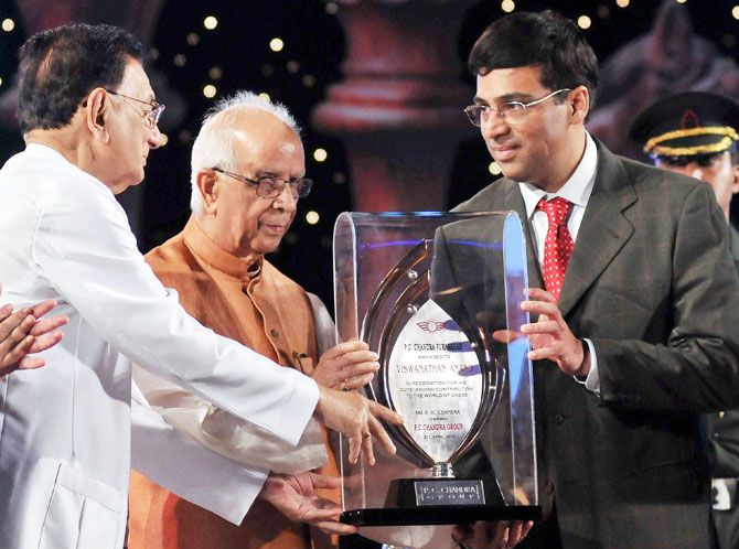 Former World Chess Champion Grand Master Viswanathan Anand felicitated with the P C Chandra Puraskar for his excellent contribution in the field of world sport by West Bengal Governor Keshari Nath Tripathi, while B K Chandra (left), Charman, PC Chandra Group looks on in Kolkata on Sunday