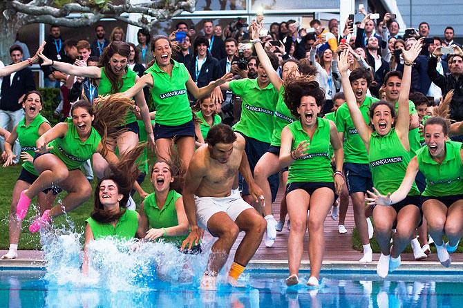 Spain's Rafael Nadal dives in the swimming pool after defeating Japan's Kei Nishikori in the Barcelona Open final at the Real Club de Tenis Barcelona, on Sunday, April 24