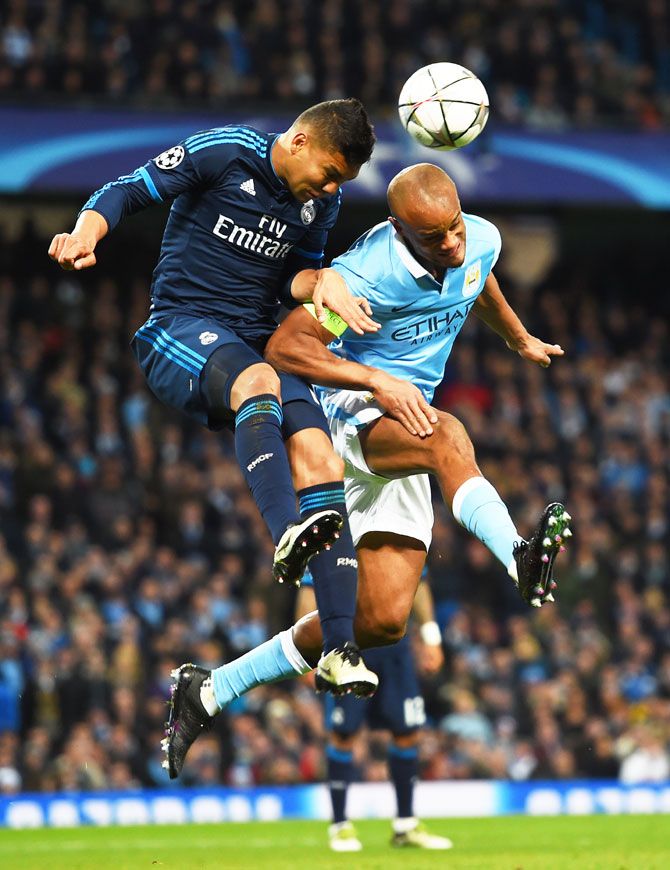 Real Madrid's Casemiro and Manchester City's Vincent Kompany are involved in an aeriel duel as they vie for possession