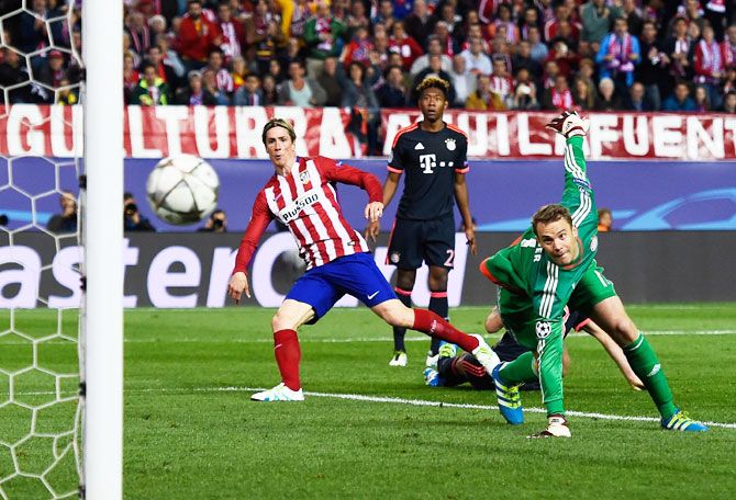 Atletico Madrid's Fernando Torres watches as his effort beats Bayern Munich's 'keeper Manuel Neuer, but only manages to hit the post