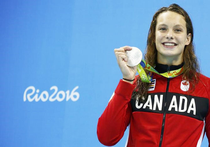 Canada's Penelope Oleksiak poses with her medal in the Women's 100m Butterfly Victory Ceremony in the Olympic Aquatics Stadium in Rio de Janeiro on Sunday