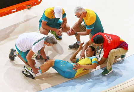 Australia  women's team member Melissa Hoskins is aided after a crash during a practice session during the preliminary team training at the Rio Olympic Velodrome on Monday