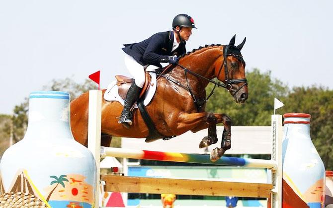 Michael Jung of Germany riding Sam jumps during the eventing team jumping final at the Equestrian event at Rio de Janeiro on Tuesday