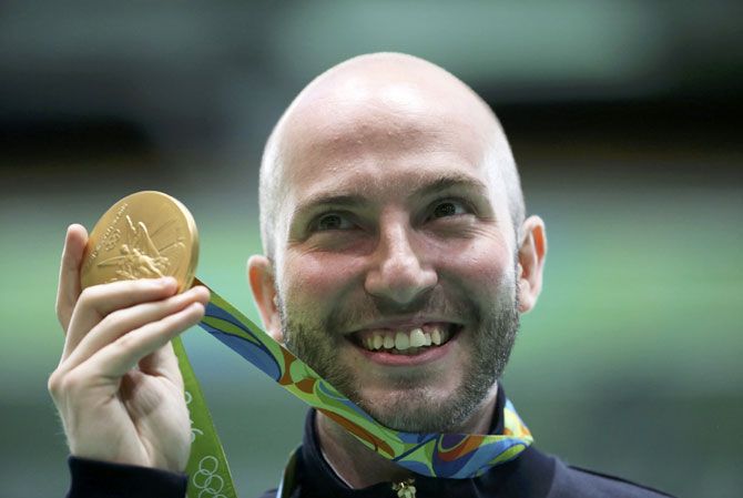 Niccolo Campriani of Italy poses with his gold medal after winning the Men's 10m Air Rifle event at the Olympic Shooting Centre on Monday