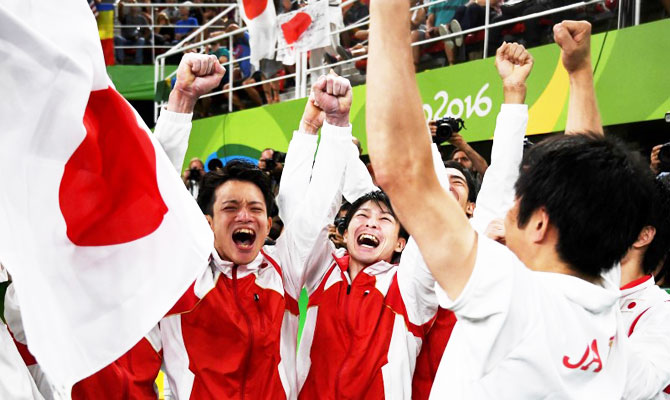  Japan gymnasts celebrate winning the men's team Artistic Gymnastics final on Monday