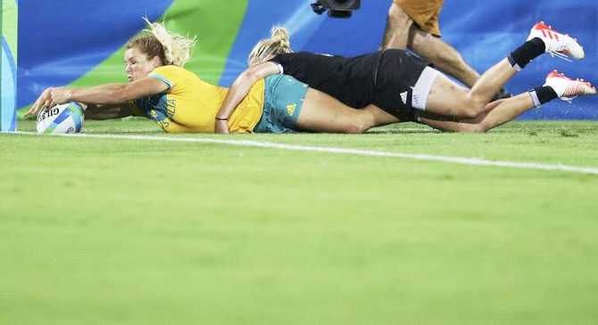Australia's Emma Tonegato scores a try during the Rugby sevens gold medal match against New Zealand on Monday