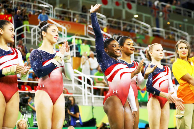 USA's Simone Biles (centre) and her teammates (from left) Laurie Hernandez, Alexandra Raisman, Gabrielle Douglas and Madison Kocian get introduced at the Artistic Gymnastics women's team final at Rio Olympic Arena, in Rio de Janeiro on Tuesday