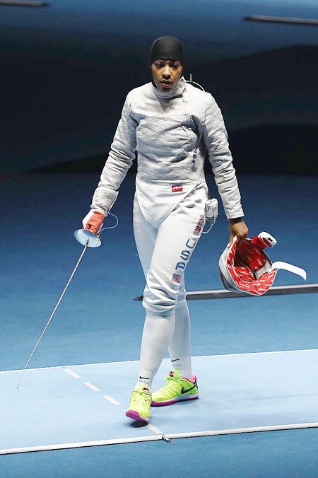 Ibtihaj Muhammad of the United States look dejected after losing to France's Cecilia Berder during the women's Individual Sabre on August 8