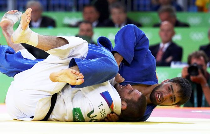 USA's Travis Stevens and Russia's Khasan Khalmurzaev are locked in as they compete in the men's 81 kg Judo final on Tuesday