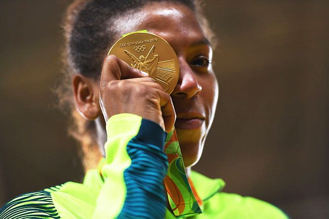 Brazil's Rafaela Silva celebrates after winning the gold medal in the Women's 57 kg judo gold medal contest on Day 3 of the Rio 2016 Olympic Games at Carioca Arena 2 in Rio de Janeiro, on Monday