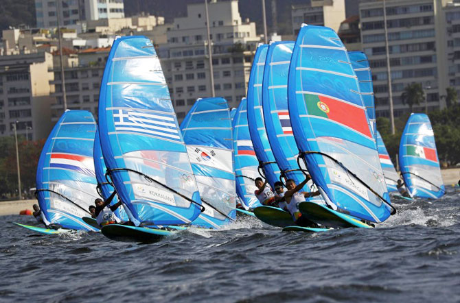 Dorian Van Rijsselberghe of the Netherlands, Byron Kokkalanis of Greece and Joao Rorigues of Portugal copete during the second race of the sailing preliminary in the men's indsurfer - RS:X  at the Marina de Gloria in Rio de Janeiro on Monday