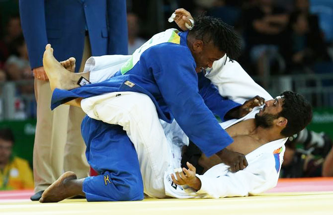 India's Avtar Singh and Refugee Olympic Athletes Popole Misenga compete during their men 90 kg Elimination Rounds at Carioca Arena 2 in Rio de Janeiro on Wednesday