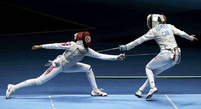 Tunisia's Ines Boubakri competes with Canada's Eleanor Harvey during their Women's Foil Individual Fencing quarter-finals at the Rio de Janeiro on Wednesday