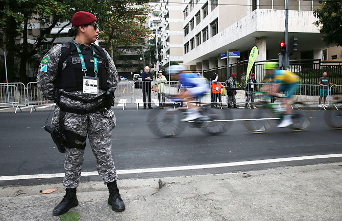 Security keeps watch during the Women's Road Race on Day 2 of the Rio 2016 Olympic Games on Sunday