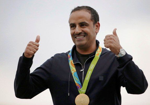 Fehaid Aldeehani of Independent Olympic Athlete poses with his men's double trap gold medal.