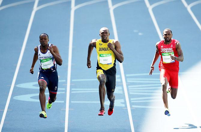 Jamaica's Usain Bolt, Trinidad and Tobago's Richard Thompson and Great Britain's James Dasaolu compete in the Men's 100m Round 1 heats at the Olympic Stadium in Rio de Janeiro on Saturday