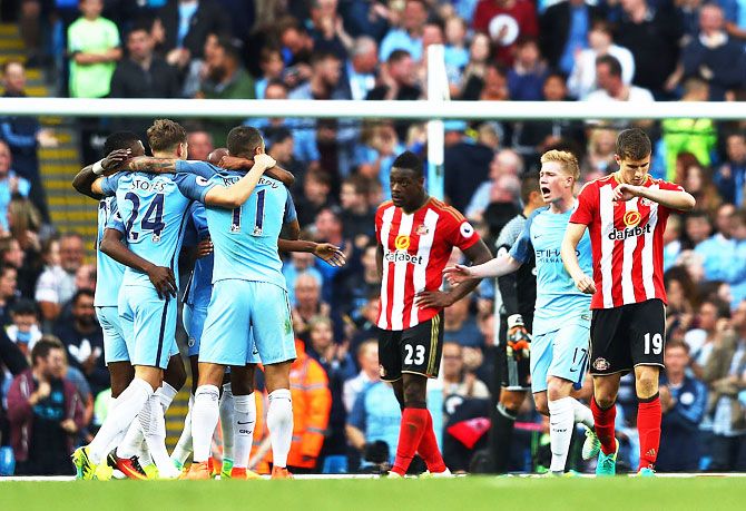 Manchester City players celebrate after Paddy McNair of Sunderland scored a own goal to score Manchester City's second goal 