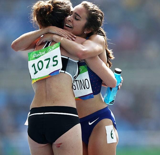 Abbey D'Agostino of the United States, right, is assisted by Nikki Hamblin of New Zealand