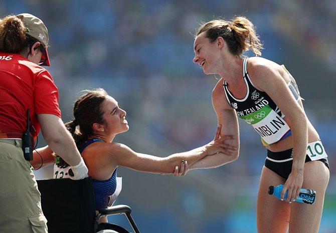 Abbey D'Agostino of the United States, right, is assisted by Nikki Hamblin of New Zealand