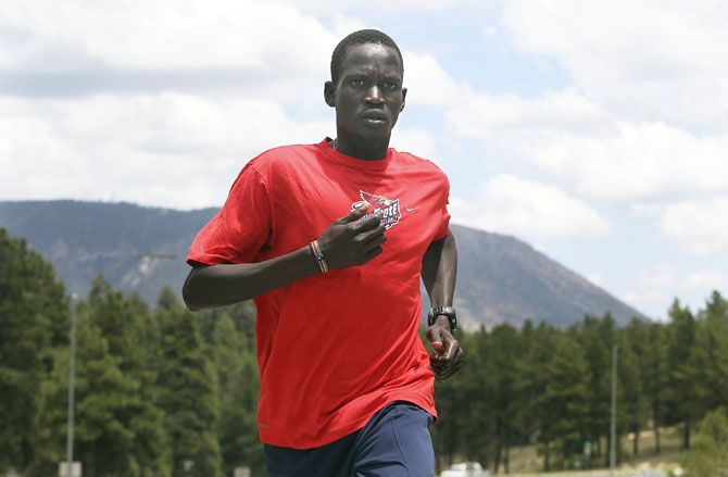 Guor Marial runs along a street in Flagstaff, Arizona during a training session in 2012