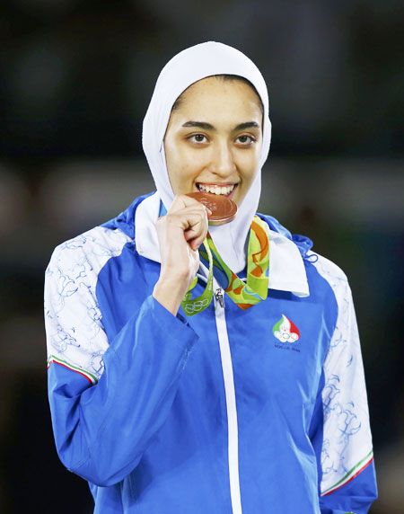 Iran's Kimia Alizadeh Zenoorin celebrates with her bronze medal after her Taekwondo, Women's -57kg win on Thursday