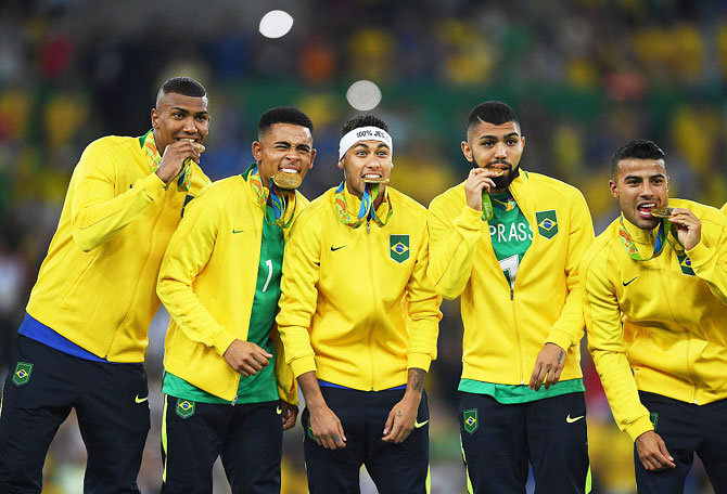 (Left-Right) Brazil's Walace, Gabriel Jesus, Neymar, Gabriel Barbosa and Rafinha celebrate with their gold medals following the football final