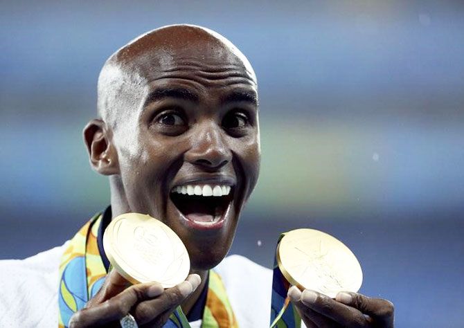 Rio Olympic gold medalist Mo Farah of Britain celebrates with his 10,000m and 5,000m medals