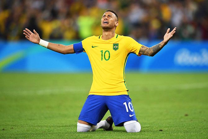 Neymar celebrates scoring the winning penalty to help Brazil win the men's football final against Germany at the Maracana Stadium at the Rio 2016 Olympic Games on August 20