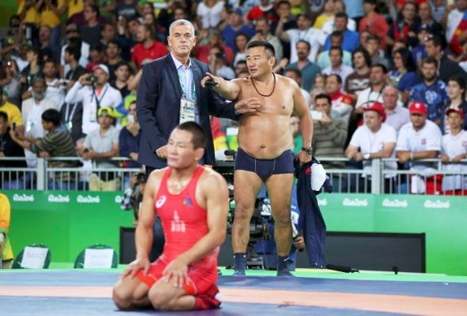 Mandakhnaran Ganzorig of Mongolia and his coach react after the match against Ikhtiyor Navruzov of Uzbekistan during the Men's Freestyle 65 kg Bronze medal wrestling match on August 21