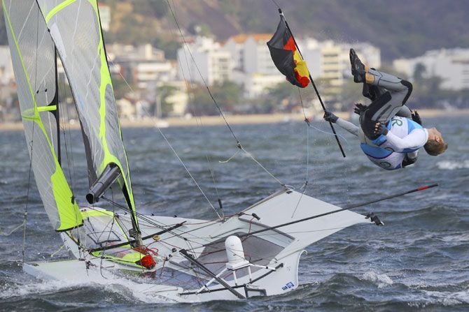 Erik Heil of Germany and team-mate Thomas Ploessel celebrate their bronze medal win in the Men's Skiff - 49er sailing event on August 18
