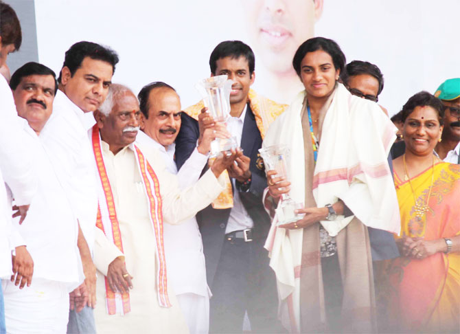 PV Sindhu and coach P Gopichand being felicitated by Telangana Govt officials on Monday