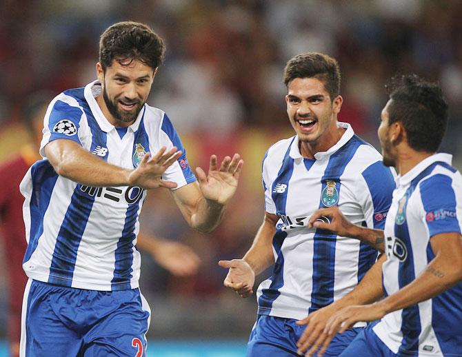 Felipe (left) with his teammates of FC Porto celebrates after scoring the opening goal during the UEFA Champions League qualifying playoff round second leg match agaist AS Roma